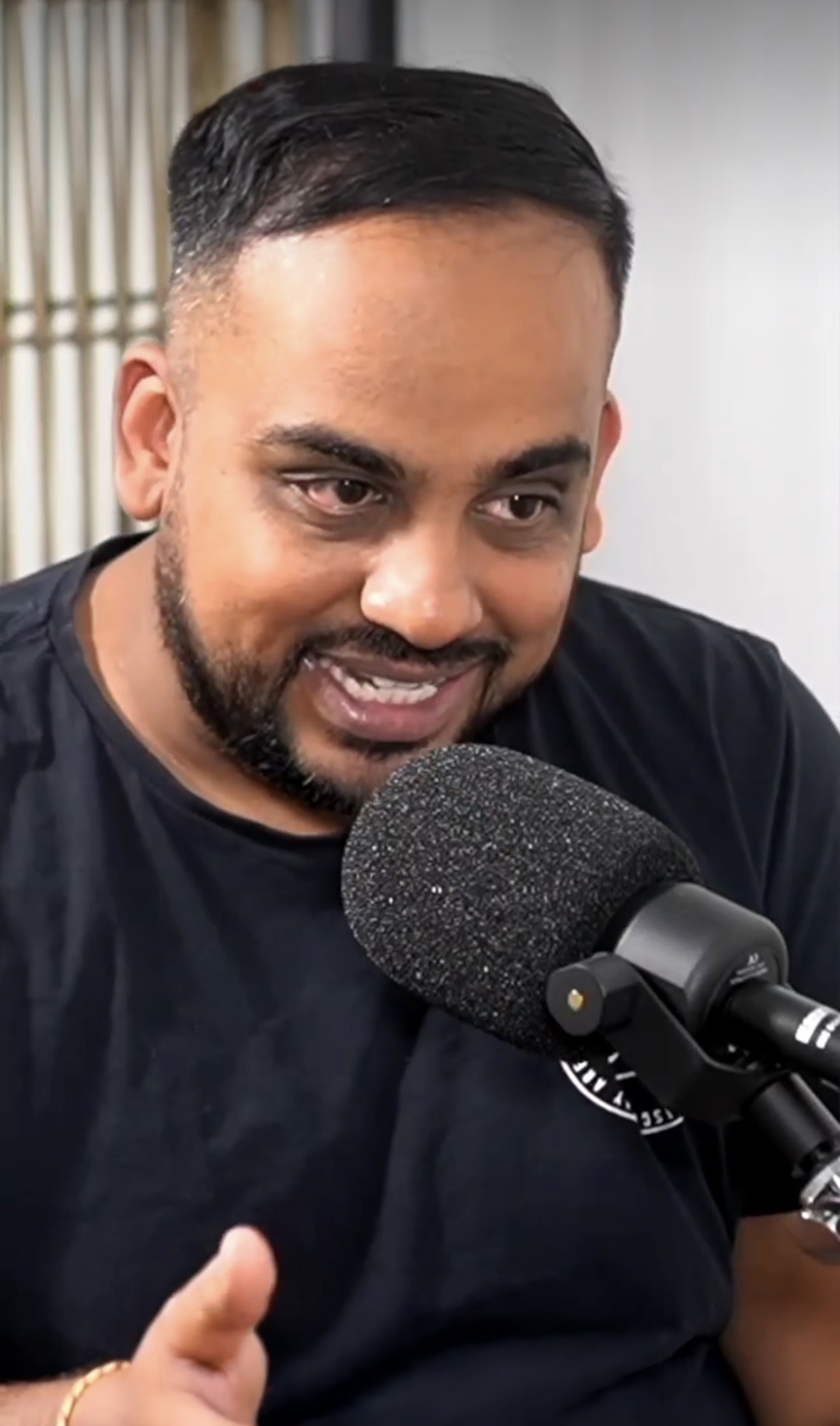 Sumeet Joseph recording content at a microphone